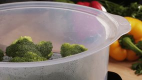 Mixed vegetables, carrots, broccoli, and cauliflower in a food double boiler steamer basket in a stainless steel pot, healthy diet cooking method preserving minerals, vitamins and flavor - Powered by Shutterstock - Get 15% off with code: PIKWIZARD15