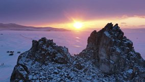 Aerial view of Shaman rock at sunset, one of sacred place in frozen lake Baikal in winter season of Siberia, Russia, 4k - Powered by Shutterstock - Get 15% off with code: PIKWIZARD15