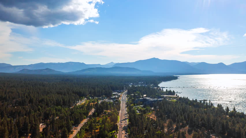 Cars Driving In The Road Along The Forest In Lake Tahoe. - aerial hyperlapse sht