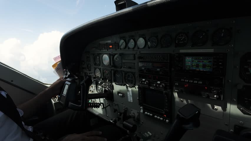 Instrument Panel And Yokes In Cockpit Of Cessna 208B Grand Caravan Aeroplane. panning shot