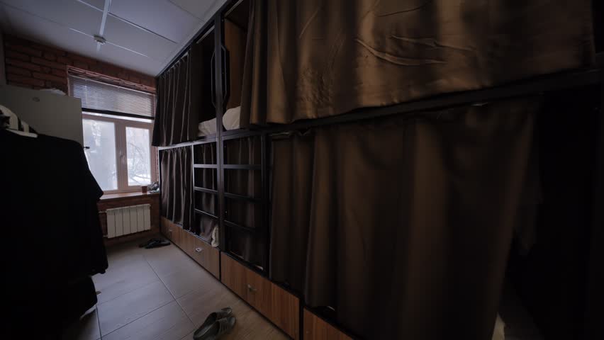 Hostel room interior showing bunk beds with curtains ensuring privacy