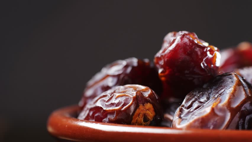 Fresh dates fruits close up on kitchen, close up in supermarket. Eating dried fruits. Vegan, vegetarian food. 