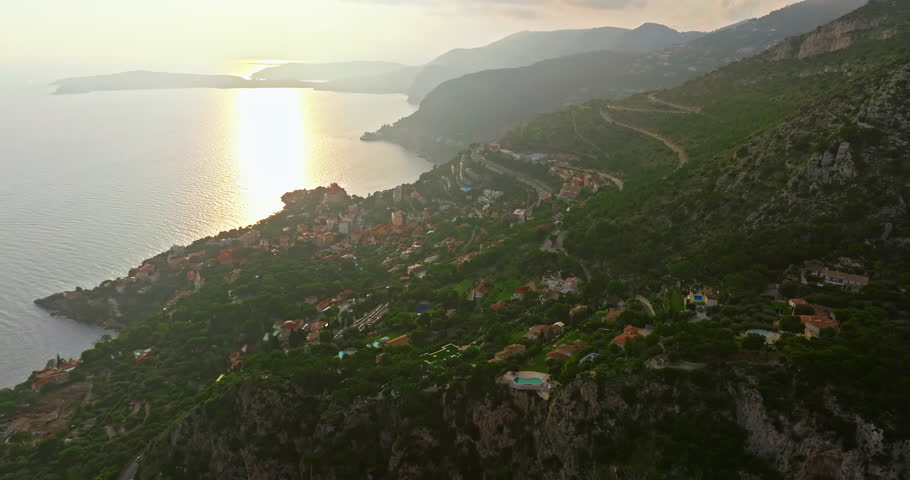 Aerial view of the city center of Monaco. Establishing shot showcases luxury yachts moored in Monaco Bay, the Palais Princier de Monaco, and luxury apartment buildings of Monte Carlo