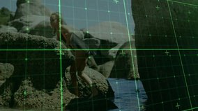 Exploring rocky shore, child interacting with digital grid overlay animation. Technology, innovation, exploration, childhood, interaction, seaside - Powered by Shutterstock - Get 15% off with code: PIKWIZARD15