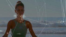 Meditating on beach, woman with data visualization overlay animation in background. Wellness, mindfulness, meditation, relaxation, tranquility, technology - Powered by Shutterstock - Get 15% off with code: PIKWIZARD15