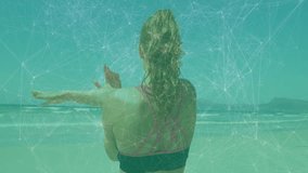 Woman in sportswear facing ocean with network connections animation overlay. Technology, fitness, outdoors, digital, futuristic, exercise - Powered by Shutterstock - Get 15% off with code: PIKWIZARD15