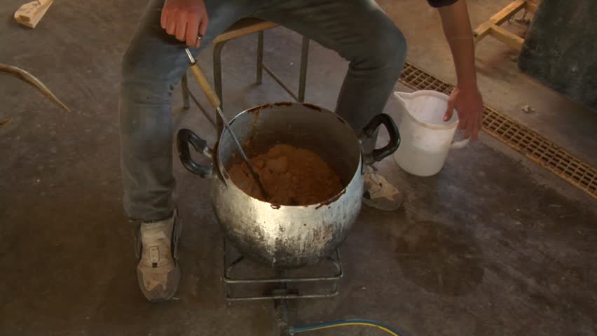 Preparing modeling clay in taxidermist laboratory