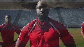 In stadium, rugby players wearing red jerseys standing confidently on field. Sports, teamwork, athletes, competition, game, match - Powered by Shutterstock - Get 15% off with code: PIKWIZARD15