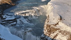 Aerial view of Gullfoss waterfall in Iceland's Suðurland, where roaring waters plunge into a deep, snowy canyon. A striking display of raw Nordic nature and winter beauty. - Powered by Shutterstock - Get 15% off with code: PIKWIZARD15