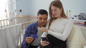 Couple sitting in a cozy bedroom, holding a credit card and smartphone, with a visible crib in the background, signifying online shopping or financial planning together. - Powered by Shutterstock - Get 15% off with code: PIKWIZARD15