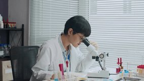 Slow motion of attractive female scientist dressed in snow white coat and wearing badge working with microscope in modern laboratory - Powered by Shutterstock - Get 15% off with code: PIKWIZARD15