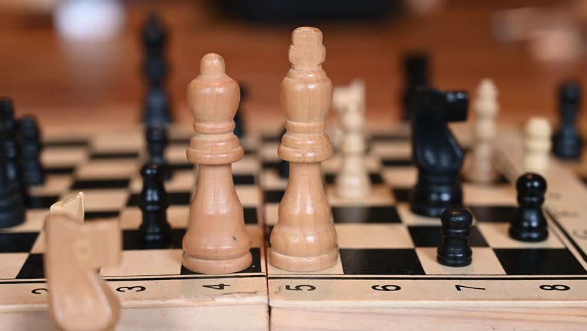 Chess pieces on a chessboard. Playing chess. Strategic game.  King and queen in first plan. 