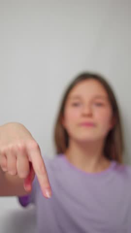 Studio shot of female hands making a vertical scrolling gesture, with the model out of focus, on a white isolated background, symbolizing motion or browsing