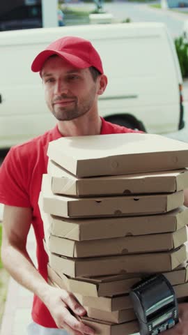 A dedicated Pizza Delivery Man skillfully Carrying Multiple Boxes of delicious pizzas