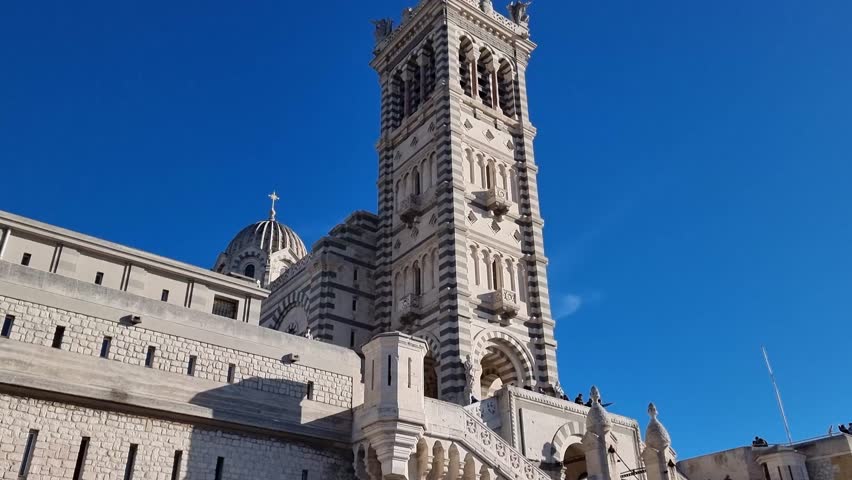 A breathtaking view of Marseille unfolds from the Basilica of Notre Dame de la Garde, showcasing the vibrant cityscape and stunning Mediterranean charm.