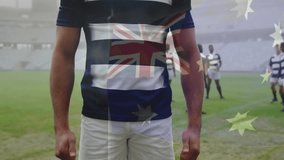 Standing confidently on field, rugby player with Australian flag animation overlay. athlete, competition, sportsmanship, nationality, teamwork, strength - Powered by Shutterstock - Get 15% off with code: PIKWIZARD15