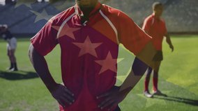 Rugby player in red jersey standing confidently with American flag animation. Sports, athlete, patriotism, championship, strength, competitive - Powered by Shutterstock - Get 15% off with code: PIKWIZARD15