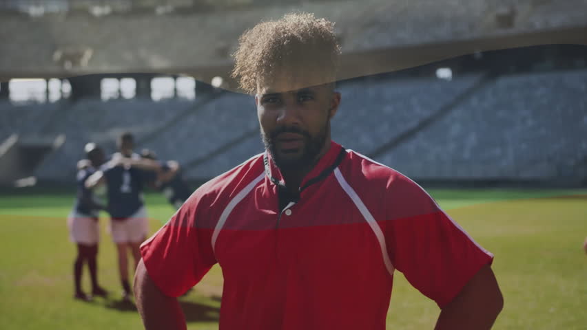 Rugby player in red jersey standing with teammates huddling on field. Sports, teamwork, athletes, huddle, competition, outdoors - Powered by Shutterstock - Get 15% off with code: PIKWIZARD15