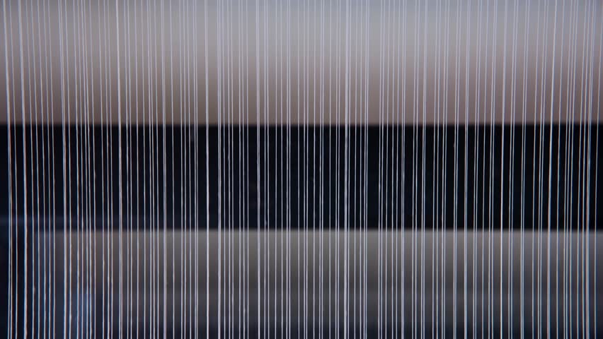 Threads of pure cotton spin around in a textile factory to clean, steam  and sort them. The early stages before dyeing and turning them into jeans.