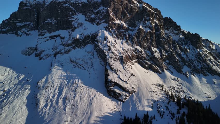 Swiss Alps mountains snow covered alpine winter Switzerland Europe, aerial drone view