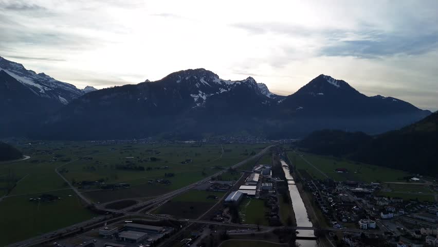 Walenstadt village Switzerland Alps snowy peak landscape skyline, aerial descend