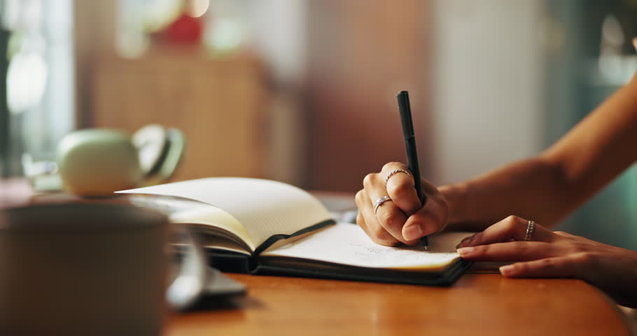 Writing, notebook and hands with pen for notes, diary entry and creative ideas on desk. Thinking, book and closeup of person for planning, schedule and agenda or to do list, calendar and journal
