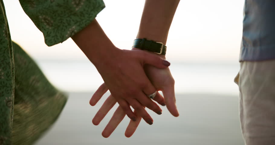 Beach, holding hands and couple with vacation, love and bonding together with unity. Closeup, seaside and people with romance, relationship and tropic island with weekend break, marriage and Zanzibar