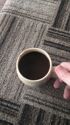 beautiful cup of coffee in hands. unusual cup. clay cup of tea. man drinking coffee. man drinking tea. live camera.