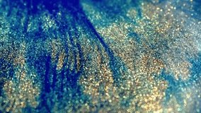 Abstract background of multicolored liquid paint. Acrylic paint with a shimmering gold glitter blend texture. Moving liquid paint with glowing particles - Powered by Shutterstock - Get 15% off with code: PIKWIZARD15