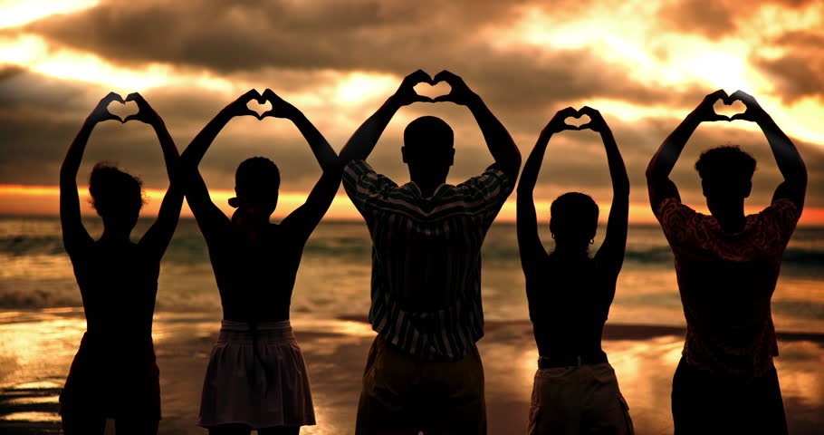 Beach, sunset and friends with heart sign for love, solidarity and bonding together on summer holiday. Group of people, silhouette and relationship with hands for shape, freedom and travel from back