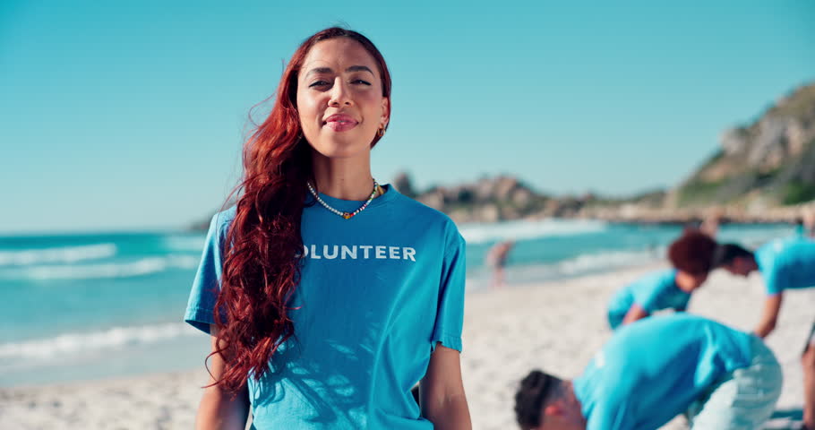 Volunteer, cleaning and face with plastic bag at beach for trash collection, coastal litter and sustainability. NGO project, girl and community service for environment conservation or waste recycling