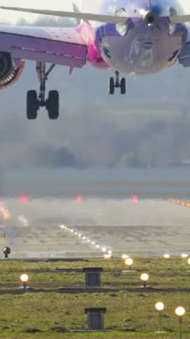 Passenger plane landing on runway. Vertical video