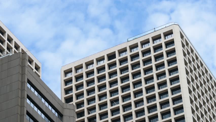 Upward view of business buildings in Hong Kong’s Central financial district, China, on a clear blue sky day.