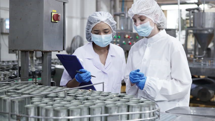 Quality control inspectors in a food processing plant