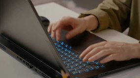Woman is diligently typing on her laptop keyboard, showcasing her focus and productivity in a cozy home office environment. The illuminated keys highlight her workspace. - Powered by Shutterstock - Get 15% off with code: PIKWIZARD15