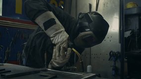 Skilled welder worker with experience in metal fabrication, using MIG welding techniques to create sparks and shape metal components, close up shot. - Powered by Shutterstock - Get 15% off with code: PIKWIZARD15