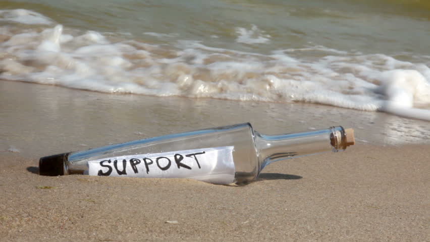Beach. Sunny weather. Sand. Surf wave brought a bottle with a note inside. It