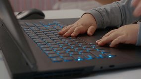 Baby's hands eagerly tap on a laptop keyboard while the mother works in her home office, showcasing early curiosity and family bonding in a modern workspace. - Powered by Shutterstock - Get 15% off with code: PIKWIZARD15