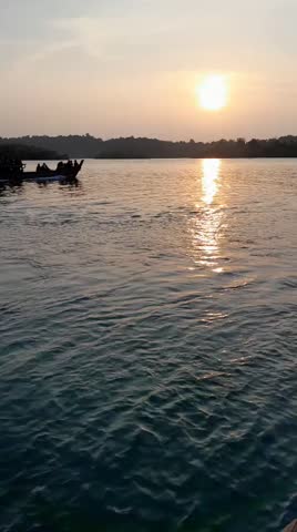 A portrait of the beautiful scenery at sunset and just below it are visitors heading back home 