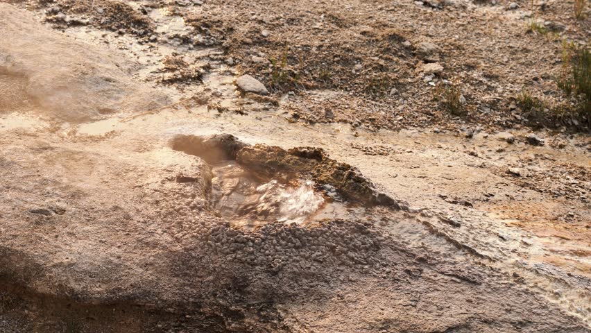 Bubbling hot spring in Yellowstone, surrounded by colorful mineral deposits and steam, geothermal power, detailed medium closeup