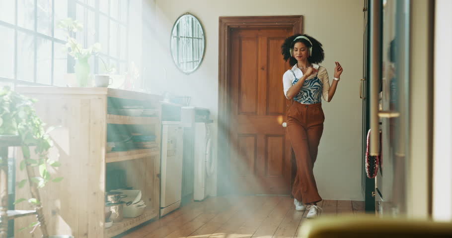 Headphones, dance and woman in apartment with music for wellness, radio and streaming. Happy student, dancer and fun girl with audio playlist in lounge, home or house for celebration or rhythm