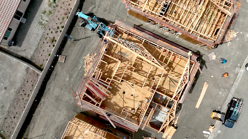 Direct Overhead Aerial Drone Flight of Workers at Home Construction Site.