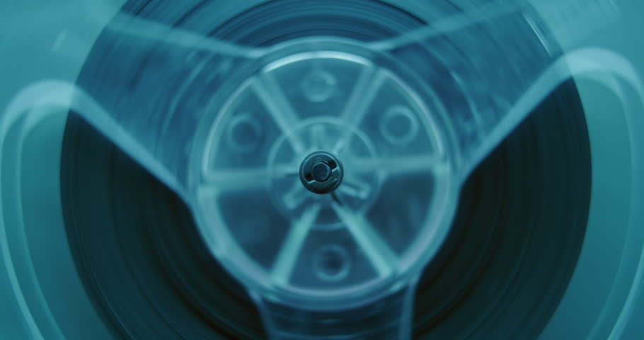 Macro Close Up of Magnetic Tape Reel on Audio Cassette Tape Spinning, Playing Mixtapes. Playback of Old Music Collection Using Hi-Fi Vintage Sound System. Cassette Player in Neon Light at 80s Party.