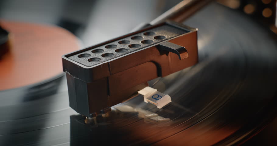Macro Close Up of Stylus Needle Touching Grooves, Playing Song on Vinyl Record Player. Vinyl Record Rotating On Retro Turntable with Old School Atmosphere. Vintage Sound Equipment for Classic Music.