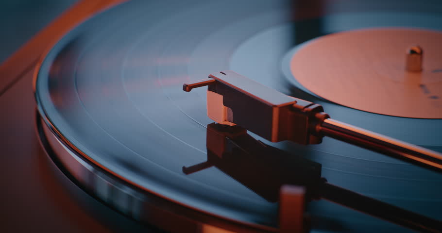 Old School Vibe Vinyl Record Player: Macro Close Up of Vinyl Record Rotating and Playing Sound on Retro Turntable Illuminated by Red Neon Lightning. Vintage Sound System for Classic Music Collection.