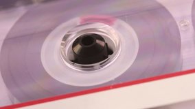 Cassette tape spins softly from angled view, revealing transparent layers and dreamy reflections of nostalgic 90s audio culture. - Powered by Shutterstock - Get 15% off with code: PIKWIZARD15