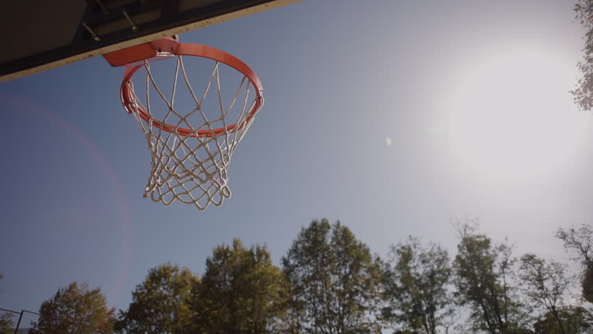 Basketball guy taking rest outdoors portrait. Young man tossing ball from hand to hand at open air stadium closeup. Positive teen posing after cardio training. Satisfied sportsman active lifestyle
