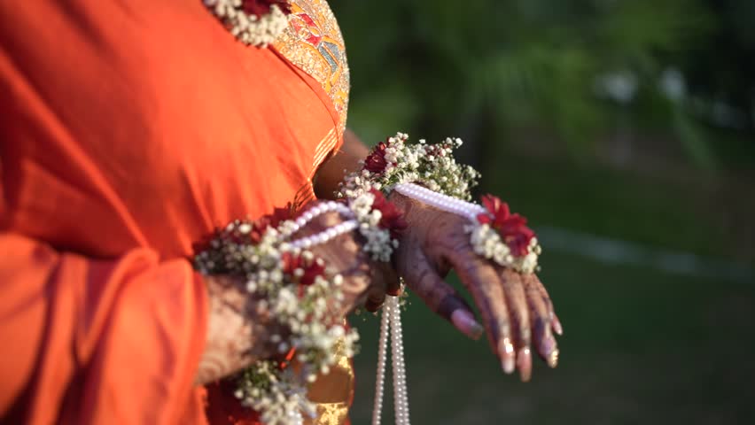 Indian Bride wearing a beautiful haldi Traditional outfit with flower ornaments in hand | Haldi Ceremony Background
