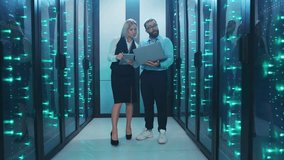 A man and woman work together in a server room, analyzing data - Powered by Shutterstock - Get 15% off with code: PIKWIZARD15