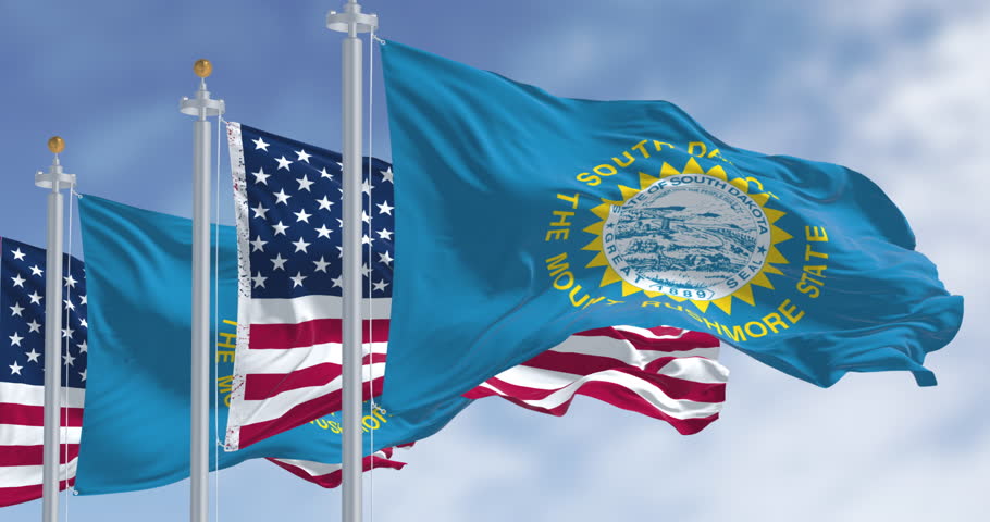 South Dakota and United States flags waving on a clear sky. A symbol of identity and resources. Seamless 3d render animation. Slow motion loop. Selective focus